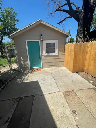 a backyard of a house with table and chairs