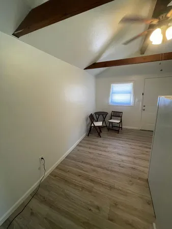 a room with furniture and a ceiling fan