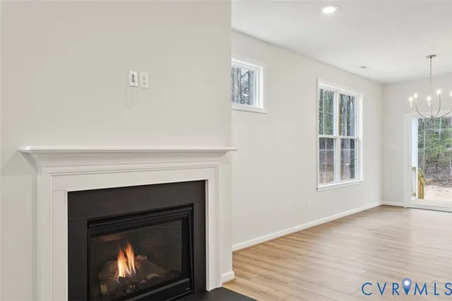 a living room with a fireplace and wooden floor