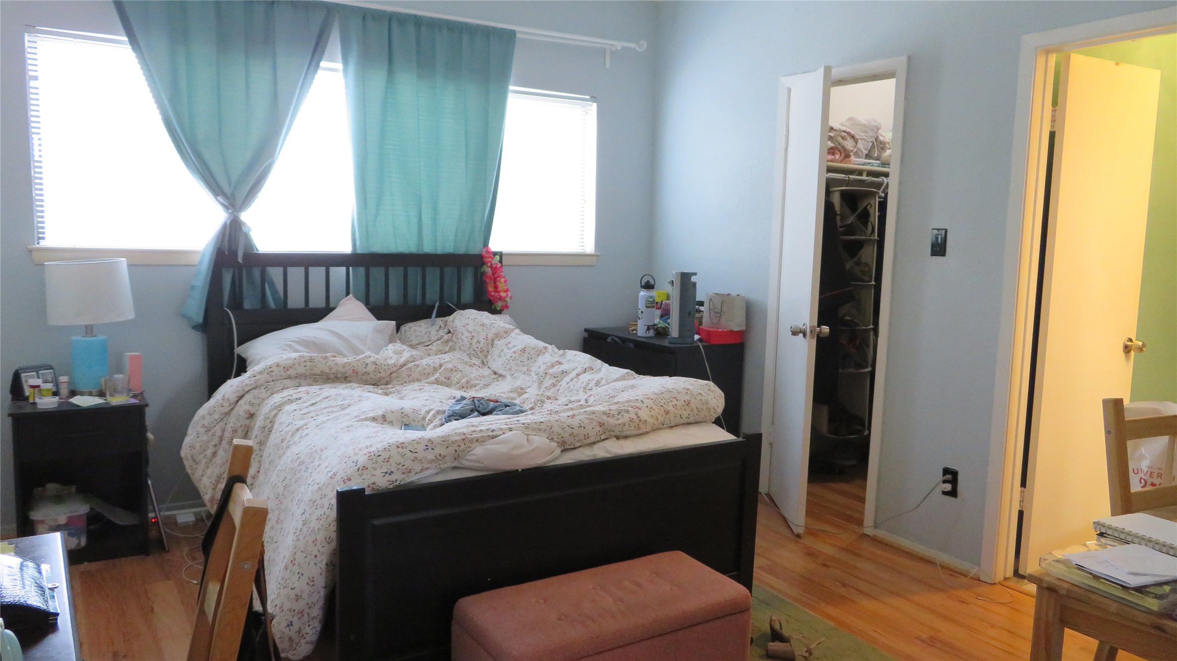 806 West 24th Street, Unit 200 Austin, TX 78705 - Photo 18 of 33 Well-lit sleeping quarters with rich hardwood flooring and a functional closet for ample storage.