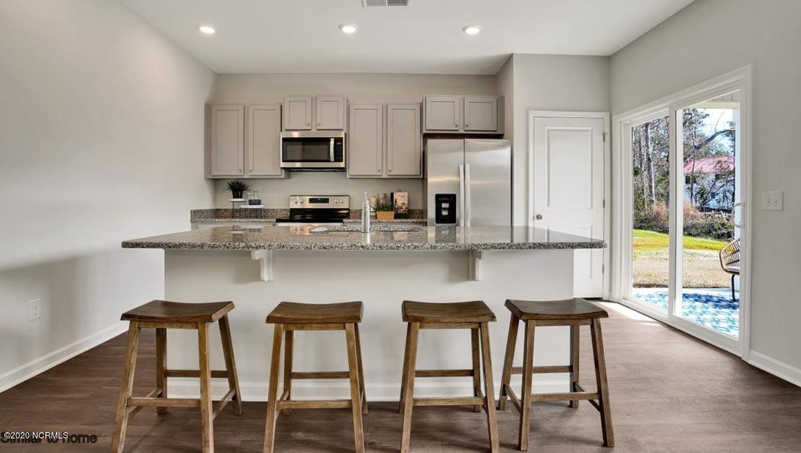 9044 St George Road, Unit LOT 25 Wilmington, NC 28411 - Photo 5 of 55 The large kitchen island has room to prepare food and while friends and family have a place to chill.