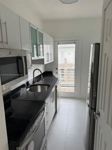 a view of a kitchen with a sink