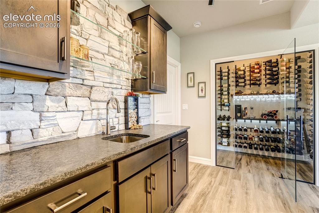 1011 Charismatic Way Colorado Springs, CO 80921 - Photo 32 of 50 Leathered granite countertops, stone backsplash, beverage storage, and exceptional entertaining functionality.