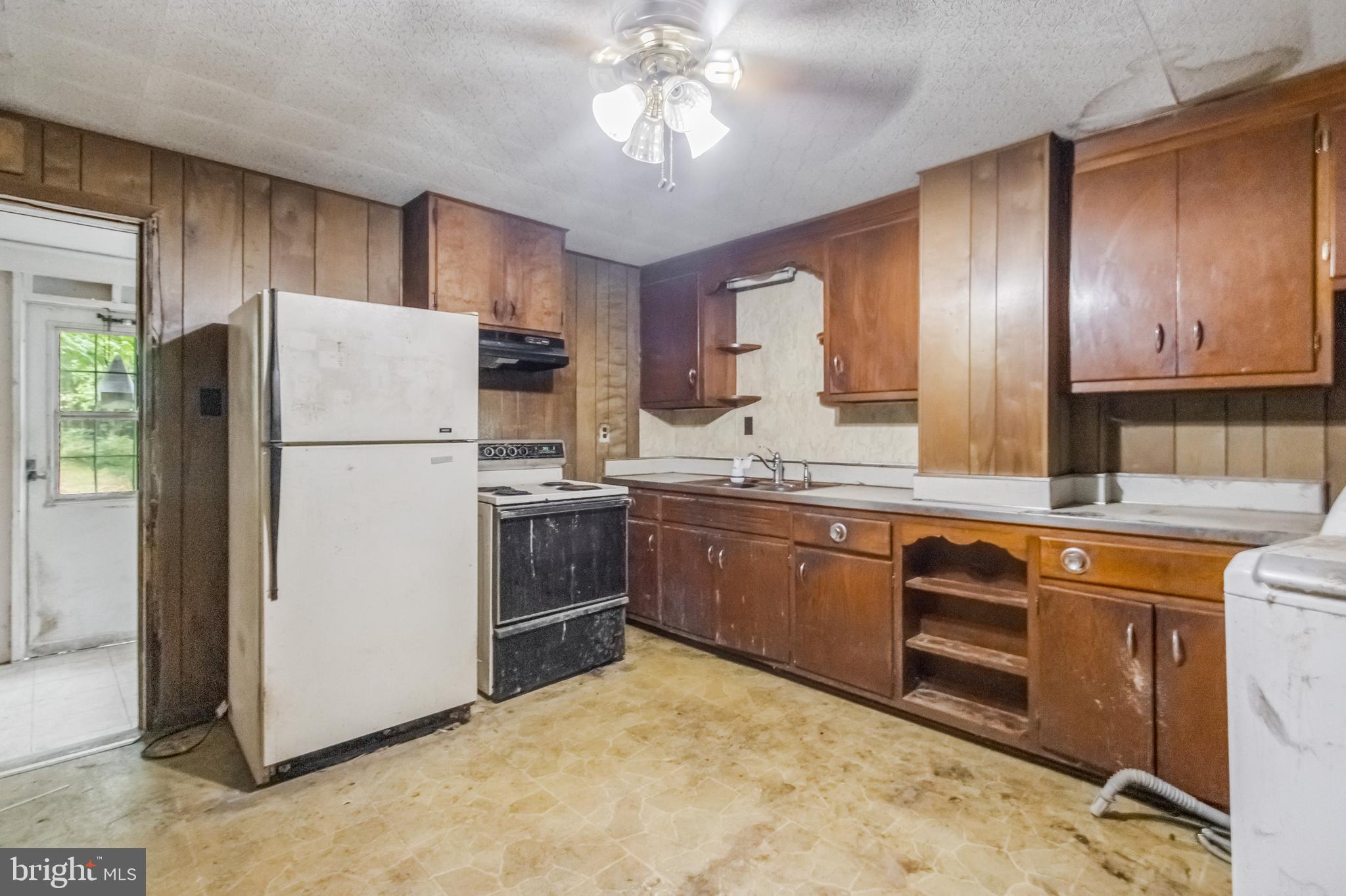4615 Bicknell Road Marbury, MD 20658 - Photo 3 of 20 a kitchen with a refrigerator sink and cabinets