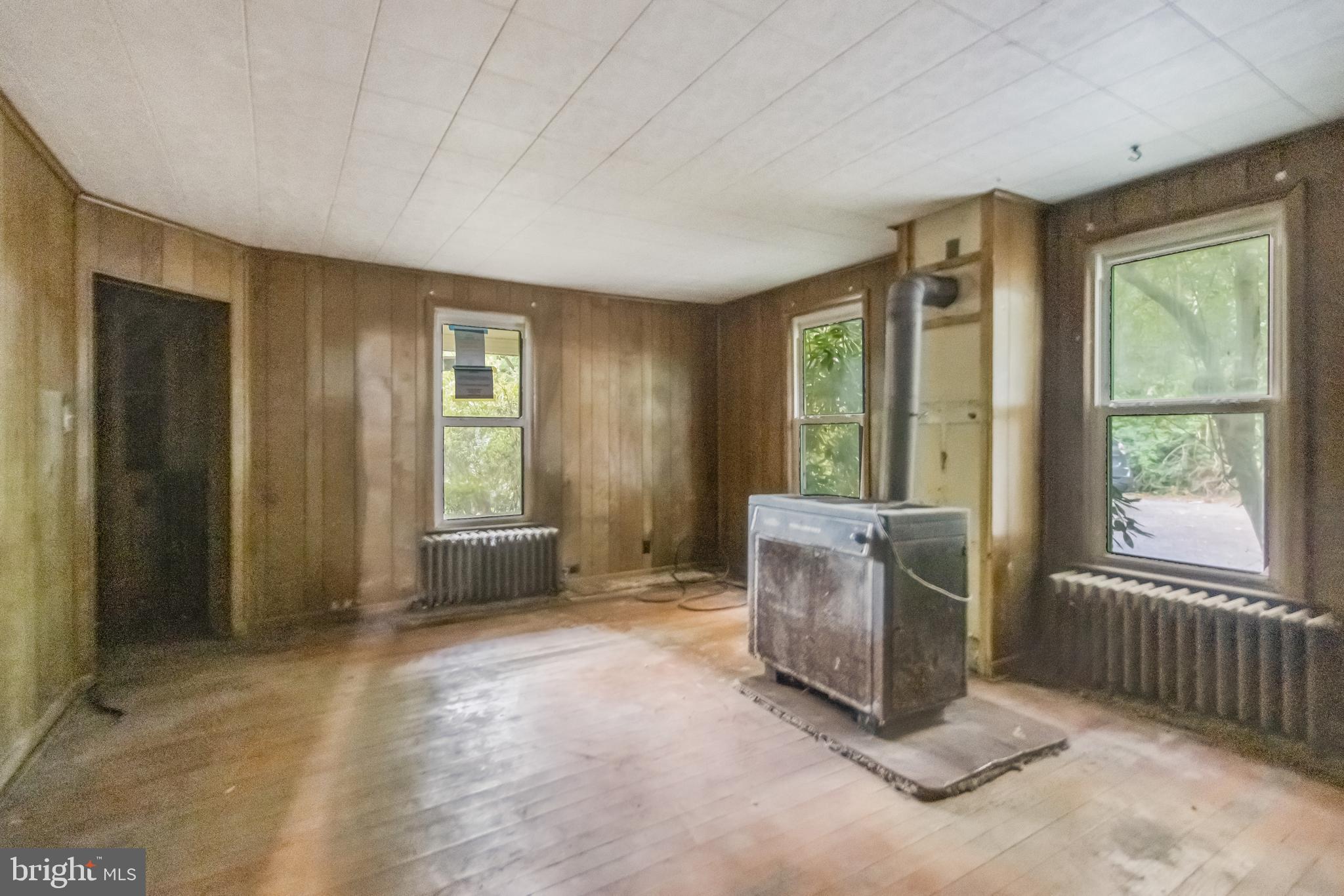4615 Bicknell Road Marbury, MD 20658 - Photo 7 of 20 an empty room with windows cabinet and front door