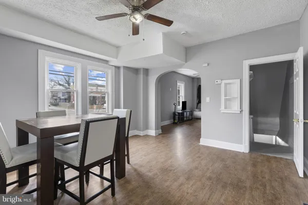 a view of a livingroom and a dining room with furniture window and wooden floor