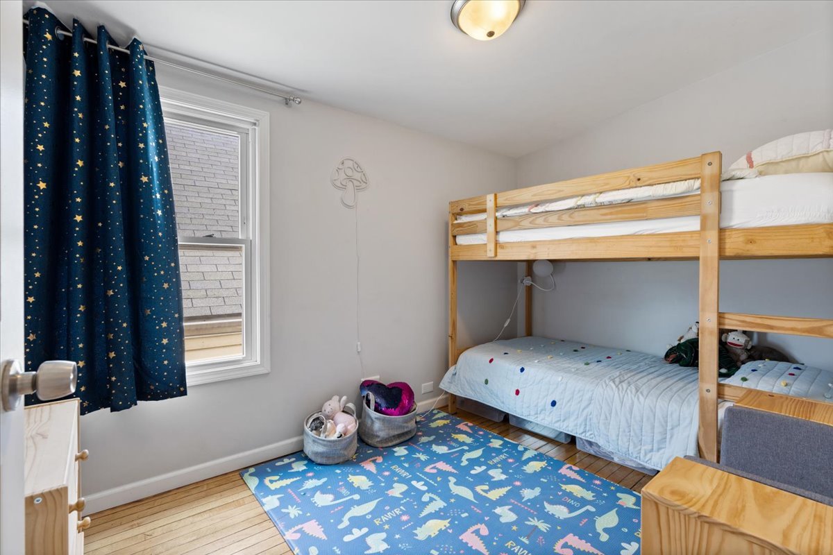 2735 North Ridgeway Avenue Chicago, IL 60647 - Photo 18 of 40 a bedroom with a bed and wooden floor