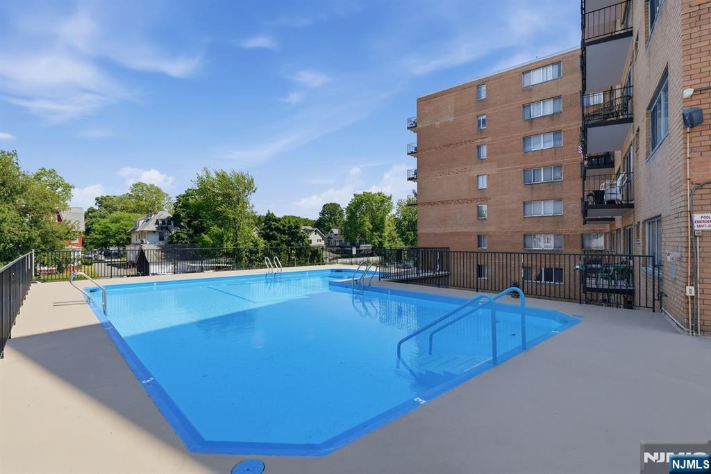265 Main Street, Unit 704 Ridgefield Park, NJ 07660 - Photo 21 of 23 a view of a swimming pool with outdoor seating