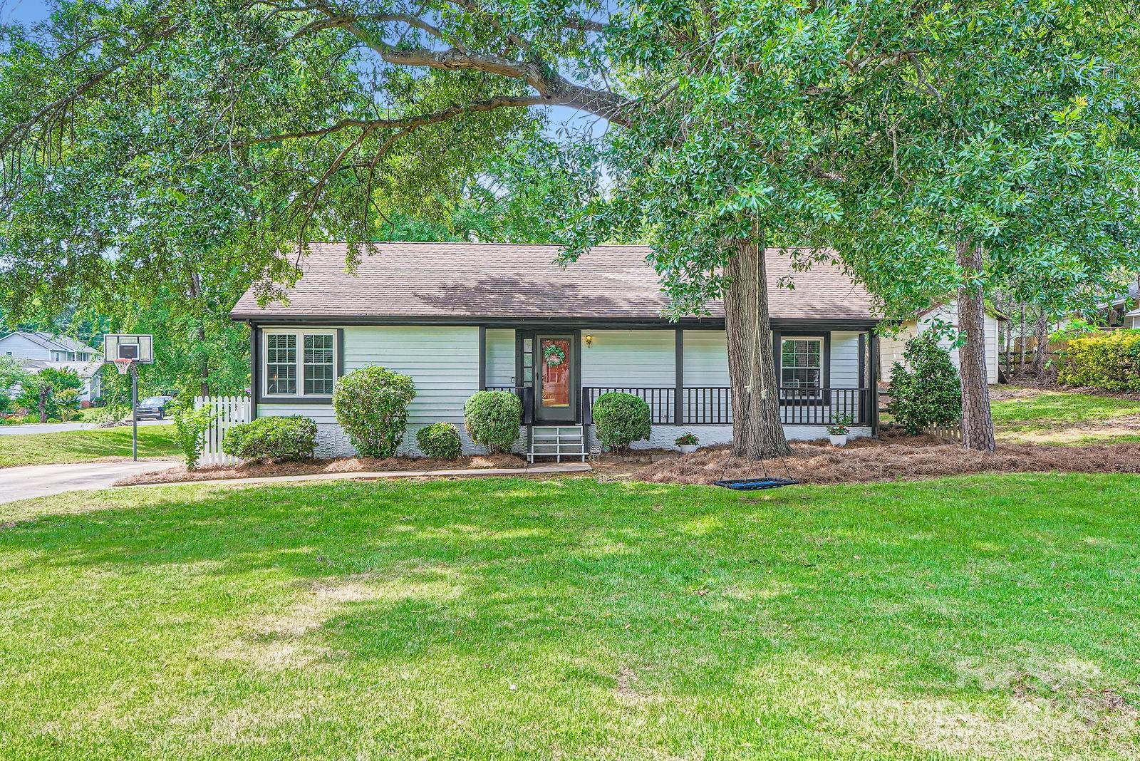 a front view of a house with swimming pool yard and patio