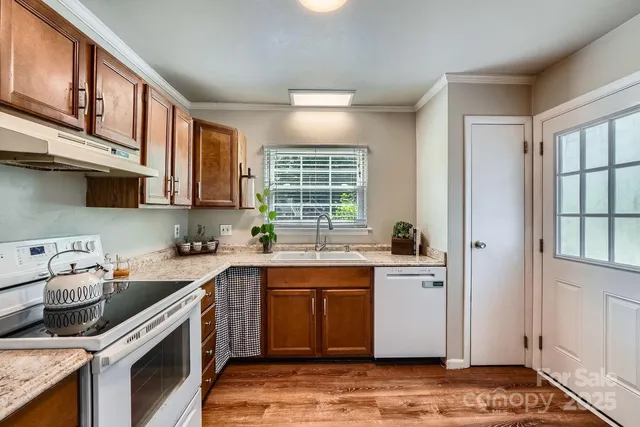 a kitchen with a sink stove and cabinets