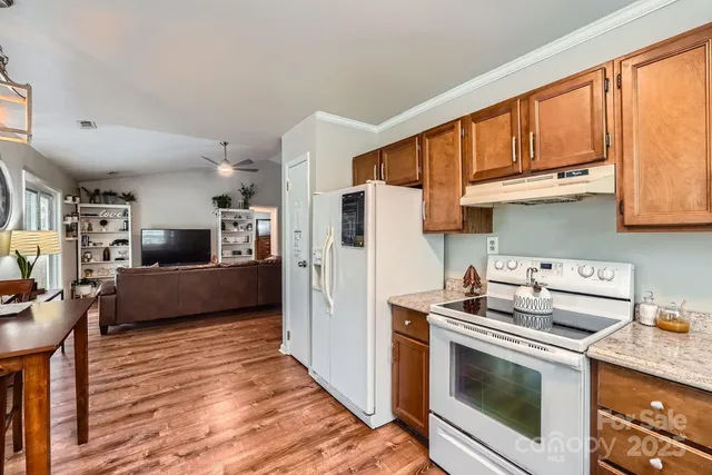 a kitchen with stainless steel appliances a stove a sink and a refrigerator