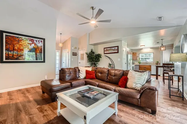 a living room with furniture a bed and a wall painting