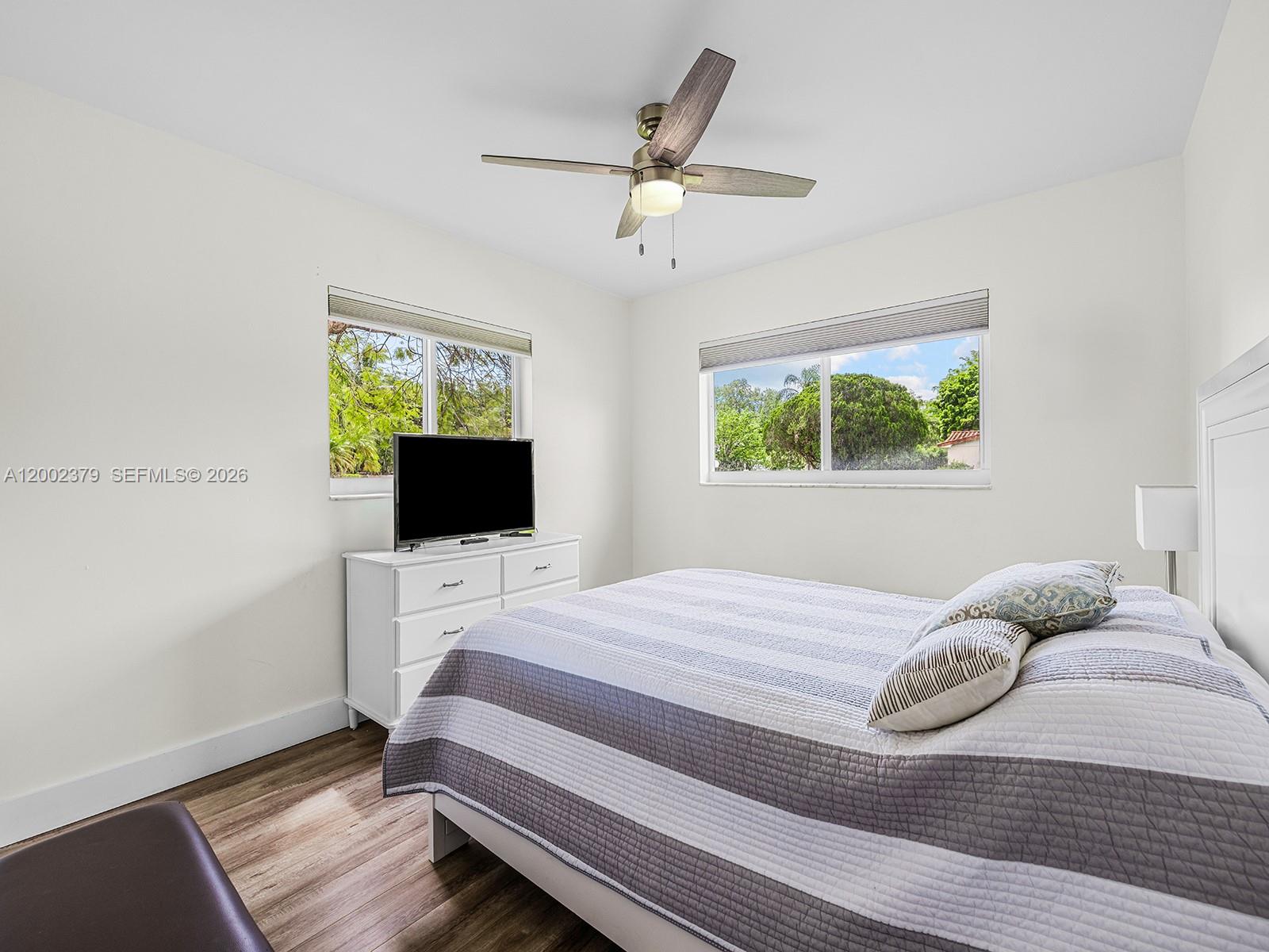7495 Southwest 73rd Terrace Miami, FL 33143 - Photo 12 of 33 a bedroom with a bed and a flat screen tv