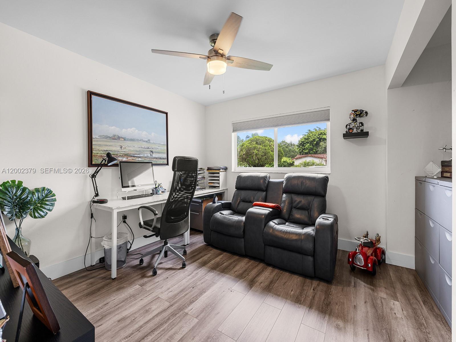 7495 Southwest 73rd Terrace Miami, FL 33143 - Photo 13 of 33 a living room with furniture and a chandelier