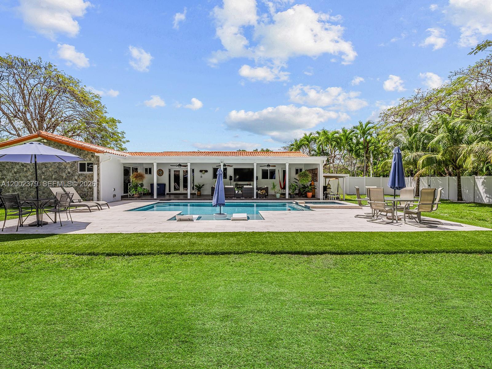 7495 Southwest 73rd Terrace Miami, FL 33143 - Photo 15 of 33 a front view of a house with swimming pool having outdoor seating