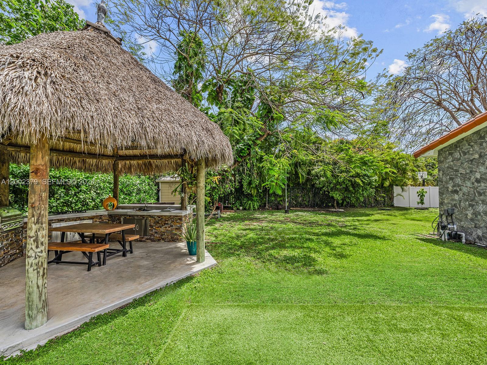 7495 Southwest 73rd Terrace Miami, FL 33143 - Photo 18 of 33 a view of backyard with seating area and green space