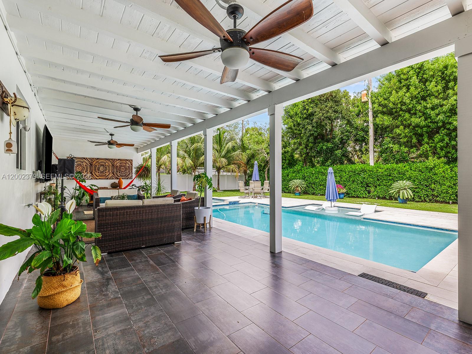7495 Southwest 73rd Terrace Miami, FL 33143 - Photo 22 of 33 a living room with patio furniture and a floor to ceiling window