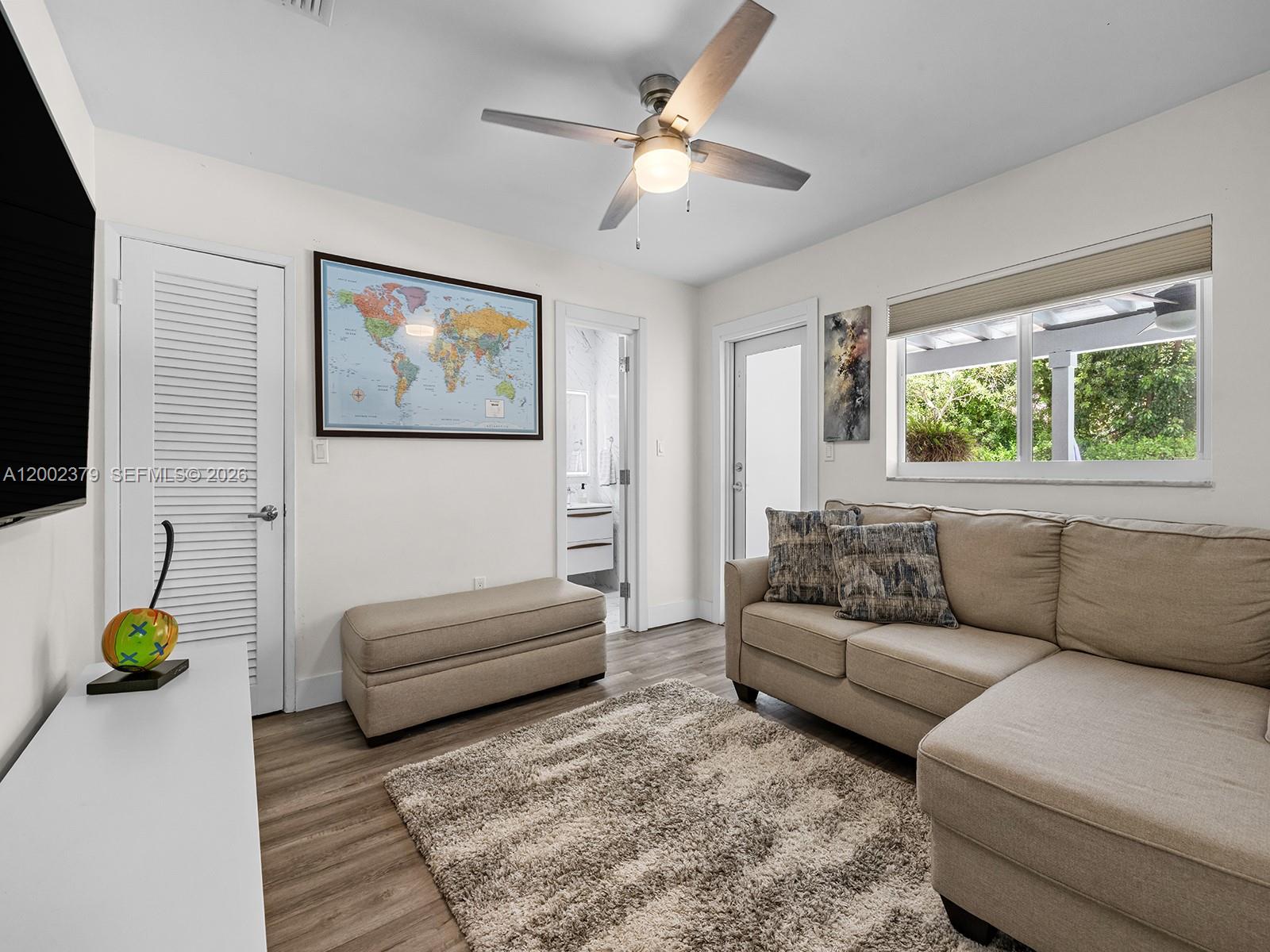 7495 Southwest 73rd Terrace Miami, FL 33143 - Photo 28 of 33 a living room with furniture a window and a flat screen tv