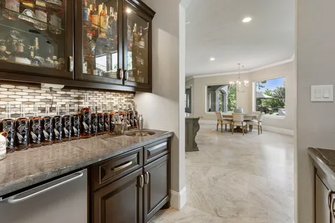 a kitchen with stainless steel appliances granite countertop a sink and cabinets