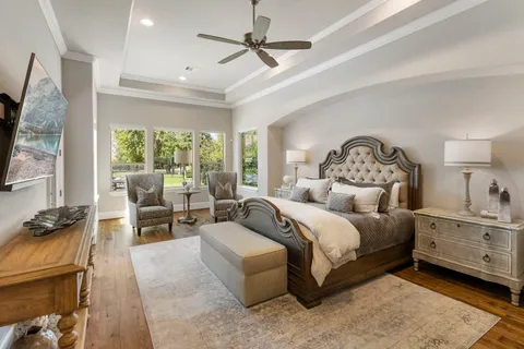 a bedroom with a bed and a chandelier