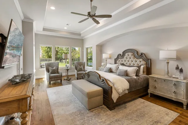 a bedroom with a bed and a chandelier