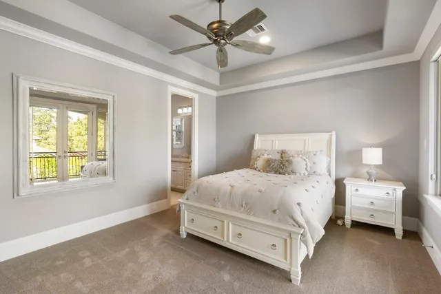 a spacious bedroom with a bed and a chandelier