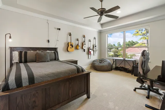 a bedroom with furniture and a large window