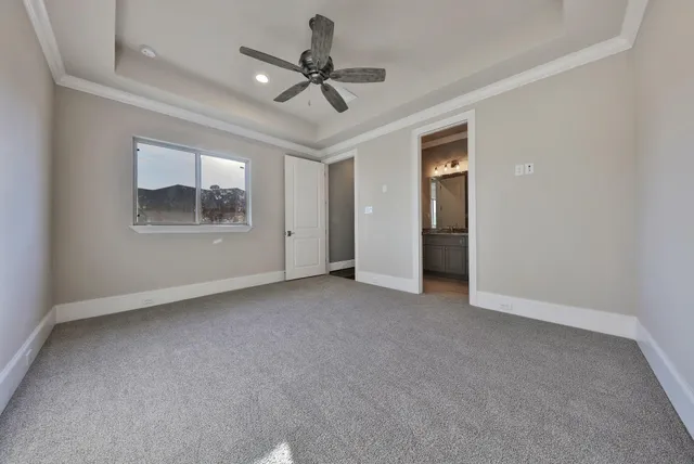 a view of a livingroom with a ceiling fan and window