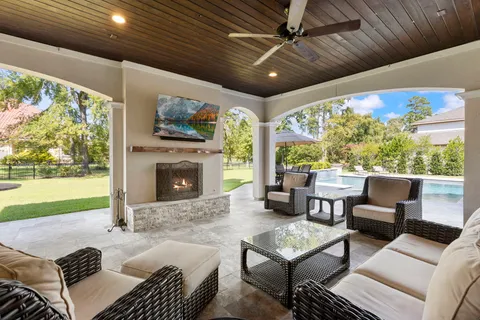 a outdoor space with patio couch and a fireplace