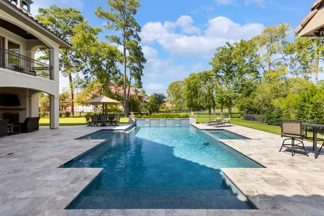 a view of a swimming pool with lounge chair