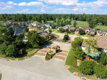 an aerial view of a residential houses with outdoor space and street view