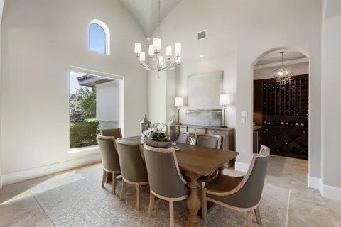 a view of a dining room with furniture and chandelier