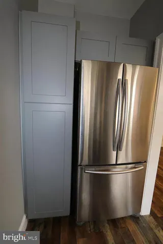 a metallic refrigerator freezer sitting in a kitchen