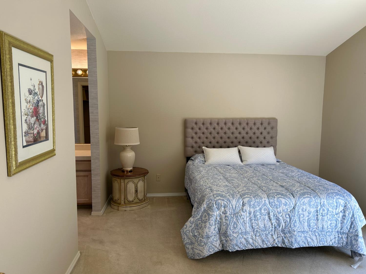 1067 Rio Cidade Way Sacramento, CA 95831 - Photo 18 of 33 a bedroom with a bed and lamp