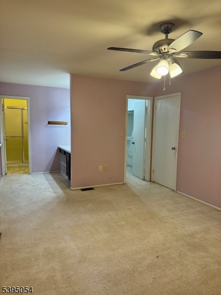92 Winchester Way Somerset, NJ 08873 - Photo 16 of 19 an empty room with a chandelier fan and a window