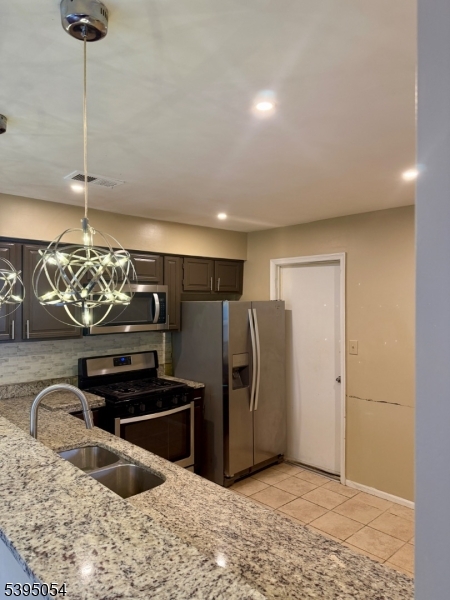 92 Winchester Way Somerset, NJ 08873 - Photo 4 of 19 a kitchen with stainless steel appliances granite countertop a refrigerator and a sink