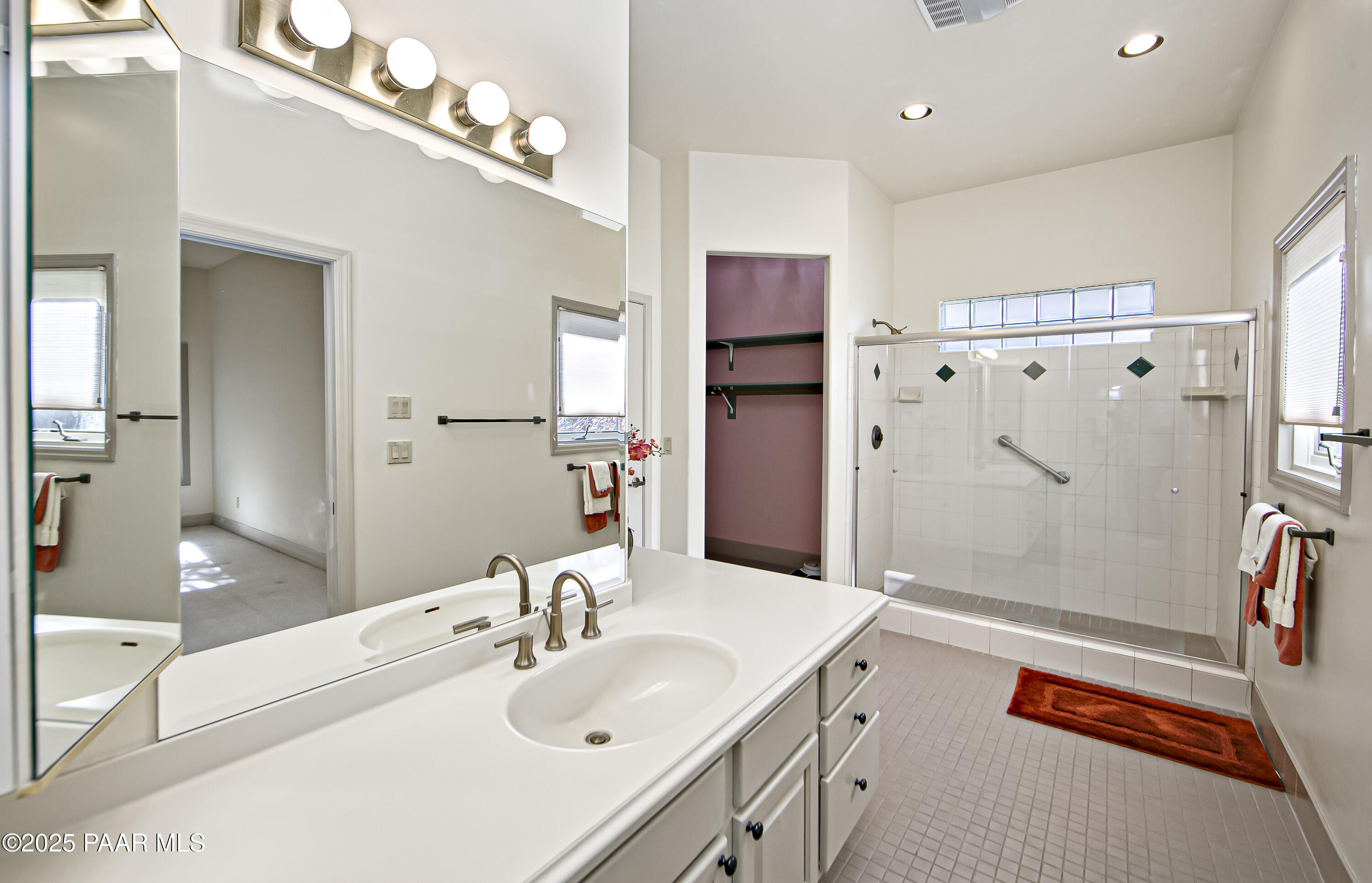 1905 Timber Point West Prescott, AZ 86303 - Photo 11 of 27 a spacious bathroom with a double vanity sink a large mirror a shower and bathtub