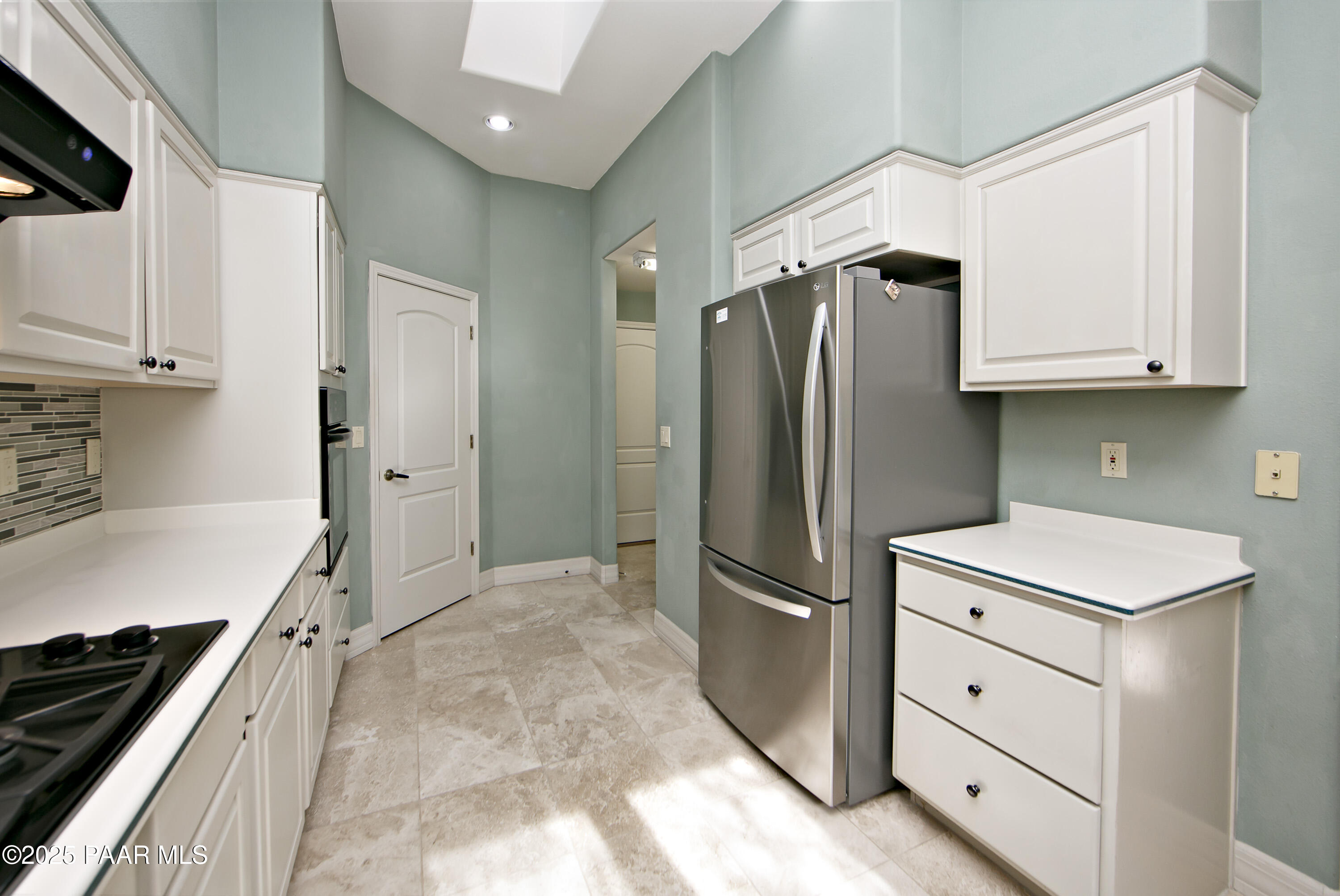 1905 Timber Point West Prescott, AZ 86303 - Photo 8 of 27 a kitchen with white cabinets and stainless steel appliances