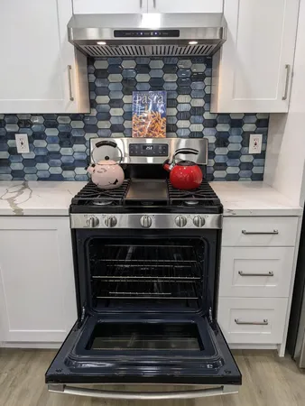 a kitchen with a stove and cabinets