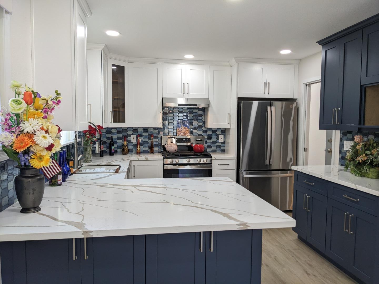 210 Springdale Drive Pacifica, CA 94044 - Photo 7 of 17 a kitchen with stainless steel appliances kitchen island granite countertop a refrigerator and a sink