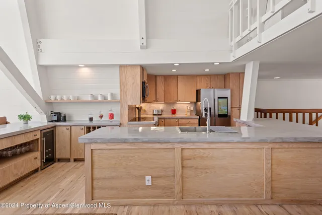 a kitchen with a sink appliances and cabinets
