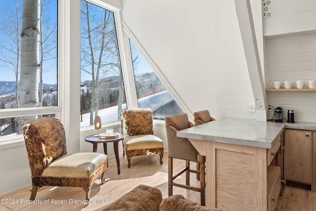 a kitchen with stainless steel appliances granite countertop a sink a stove and a wooden floors