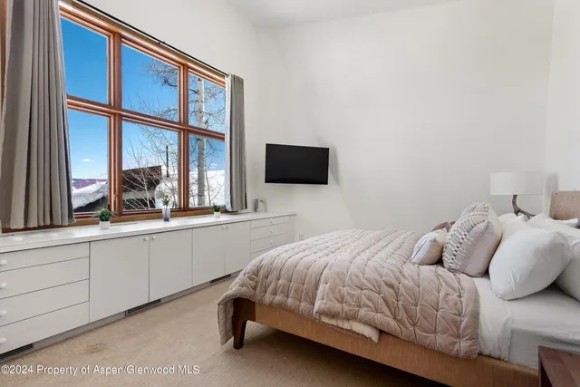 a living room with furniture a large window and table