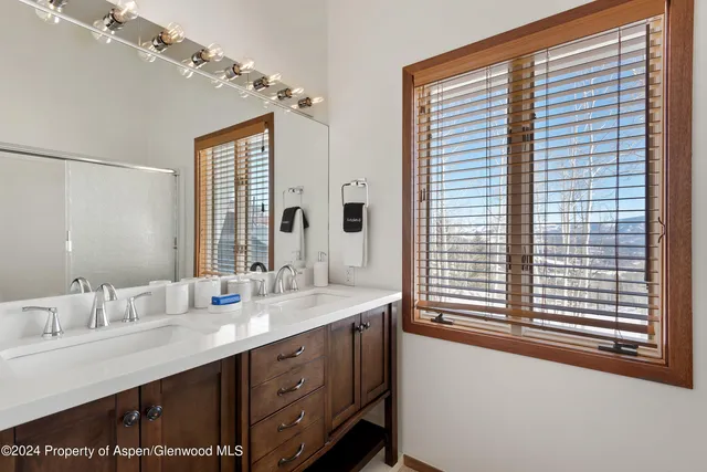 a bedroom with a bed and windows