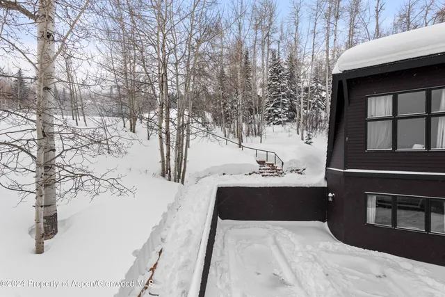 a view of a room with furniture and wooden floor