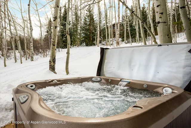 a view of a patio with table and chairs with wooden floor and fence