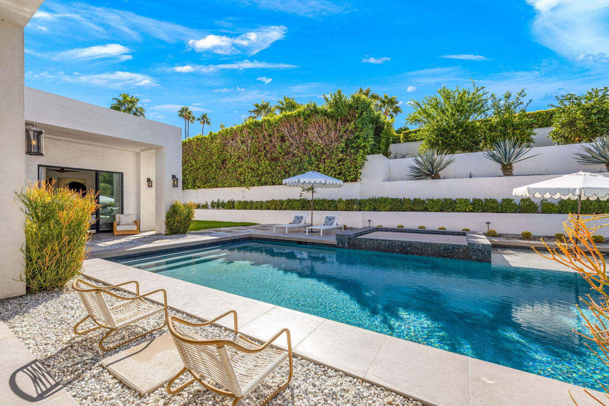 70481 Placerville Road Rancho Mirage, CA 92270 - Photo 23 of 42 a view of a swimming pool with an outdoor seating and a garden