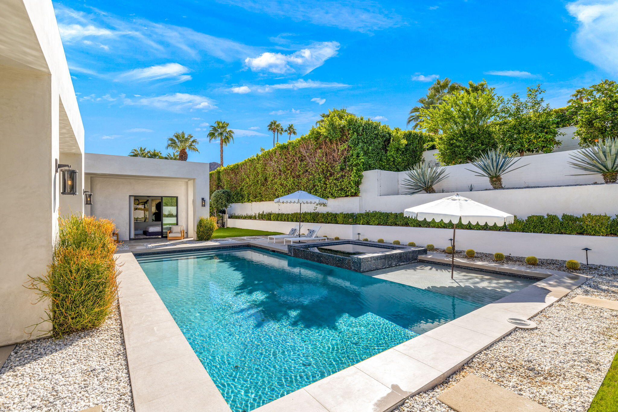 70481 Placerville Road Rancho Mirage, CA 92270 - Photo 37 of 42 a view of swimming pool with lawn chairs and potted plants