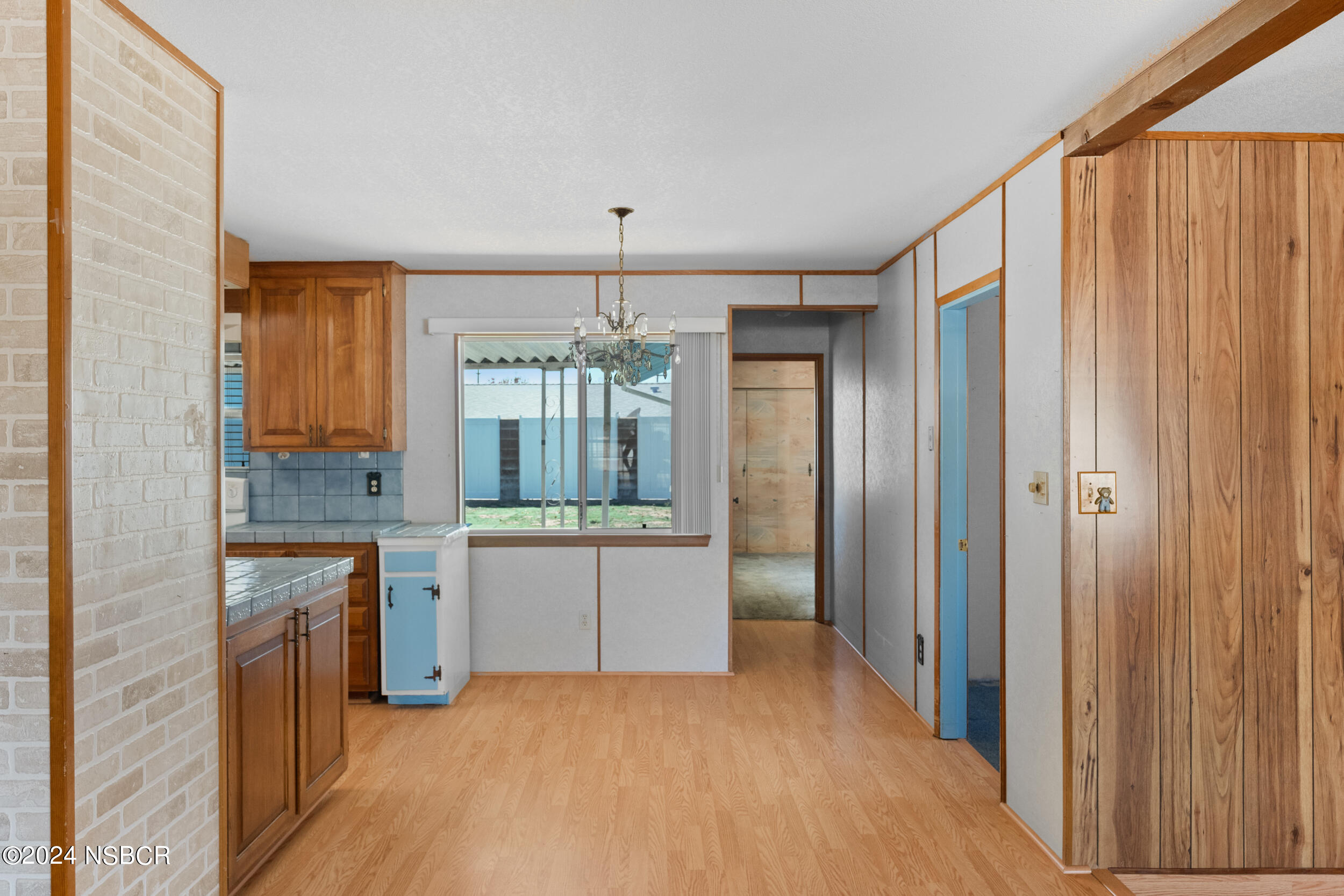 4188 Constellation Road Lompoc, CA 93436 - Photo 13 of 37 a room with kitchen island granite countertop furniture and a chandelier