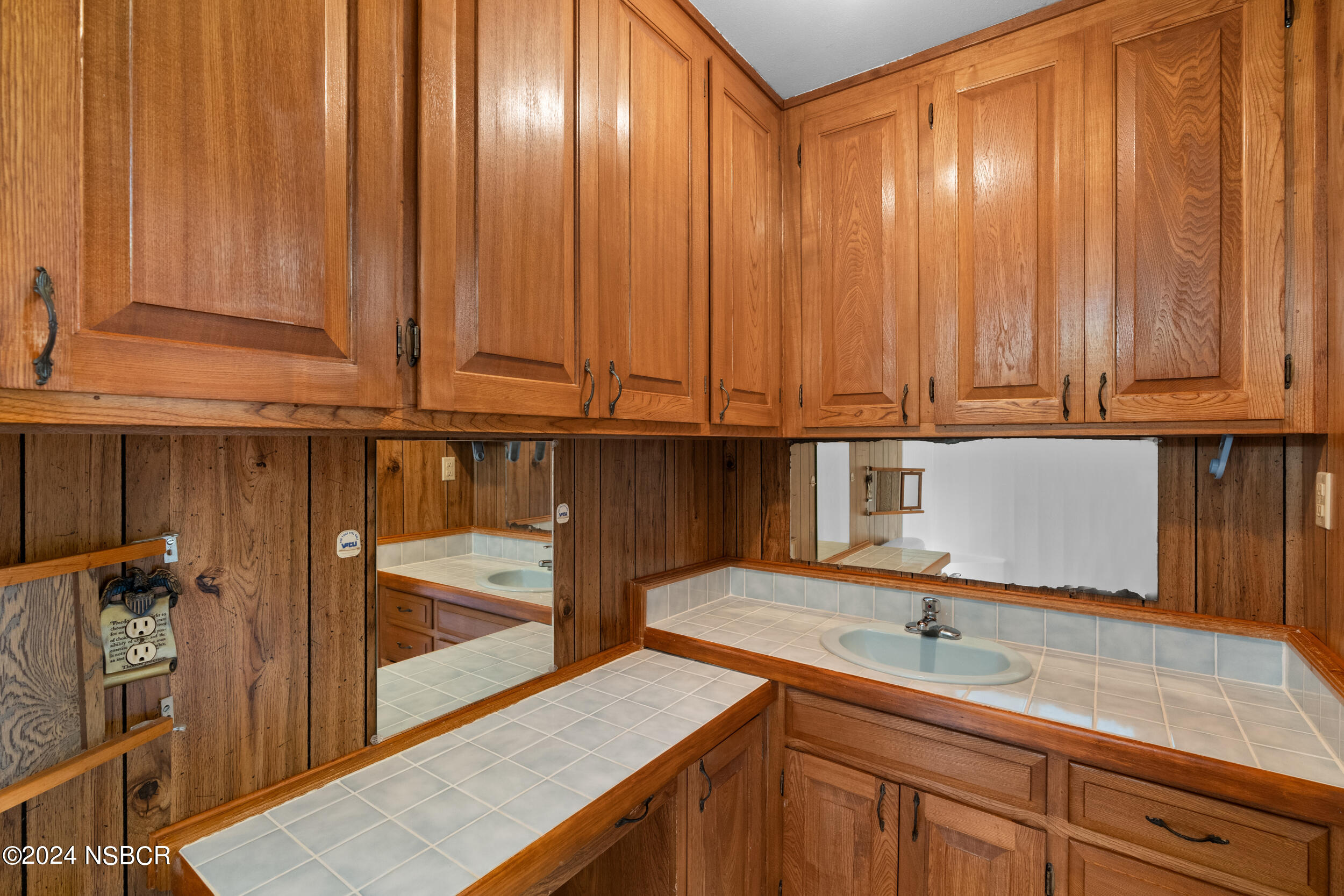 4188 Constellation Road Lompoc, CA 93436 - Photo 22 of 37 a kitchen with stainless steel appliances granite countertop a sink a stove and a microwave oven with wooden floor